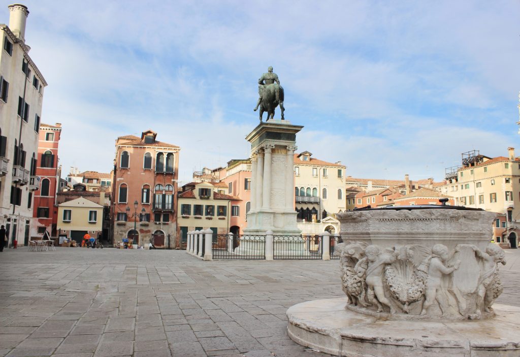 wide place with fountain and sculpture of man with horse in Venice