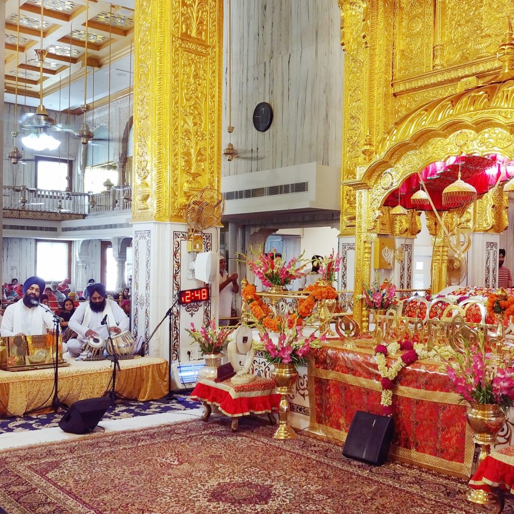 the main room for prayers is so colorful with gold pilars