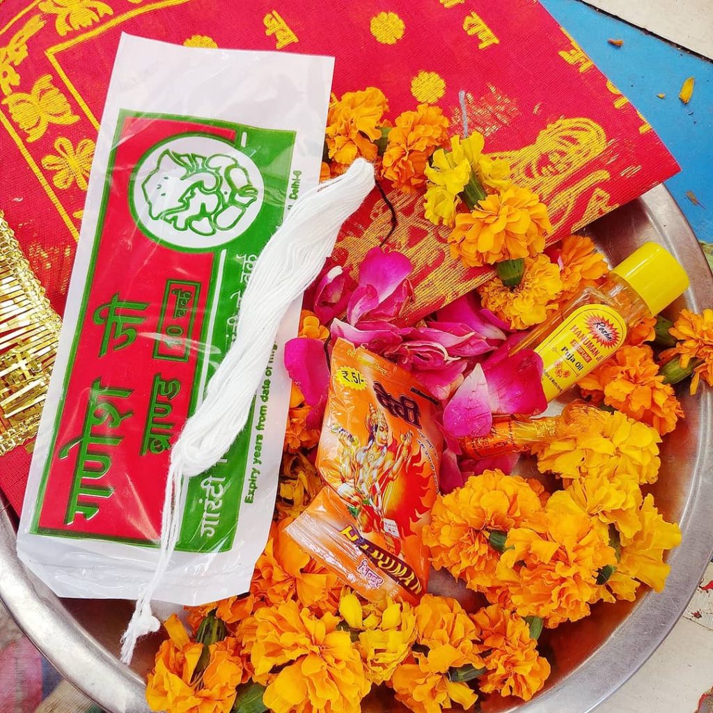 a bowl of flowers and perfums to offer to gods inside the temple