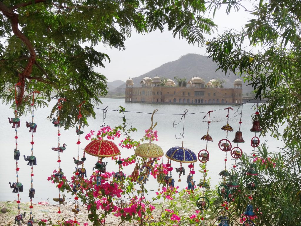 one of thebest place to see in Jaipur - the beautiful water palace Jal Mahal and some handicrafts souvenirs hanging from the trees