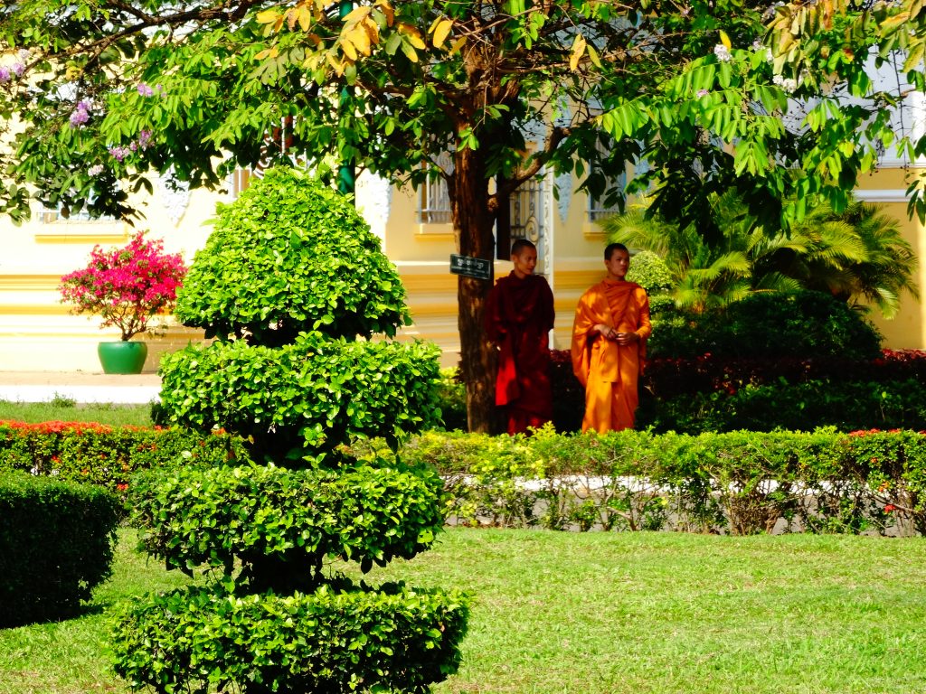 two monks walkign into the gardens of the royal palace