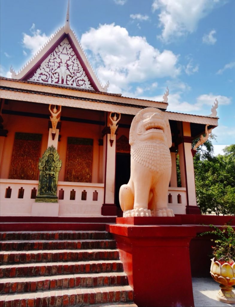 a lion statue protects the pagoda