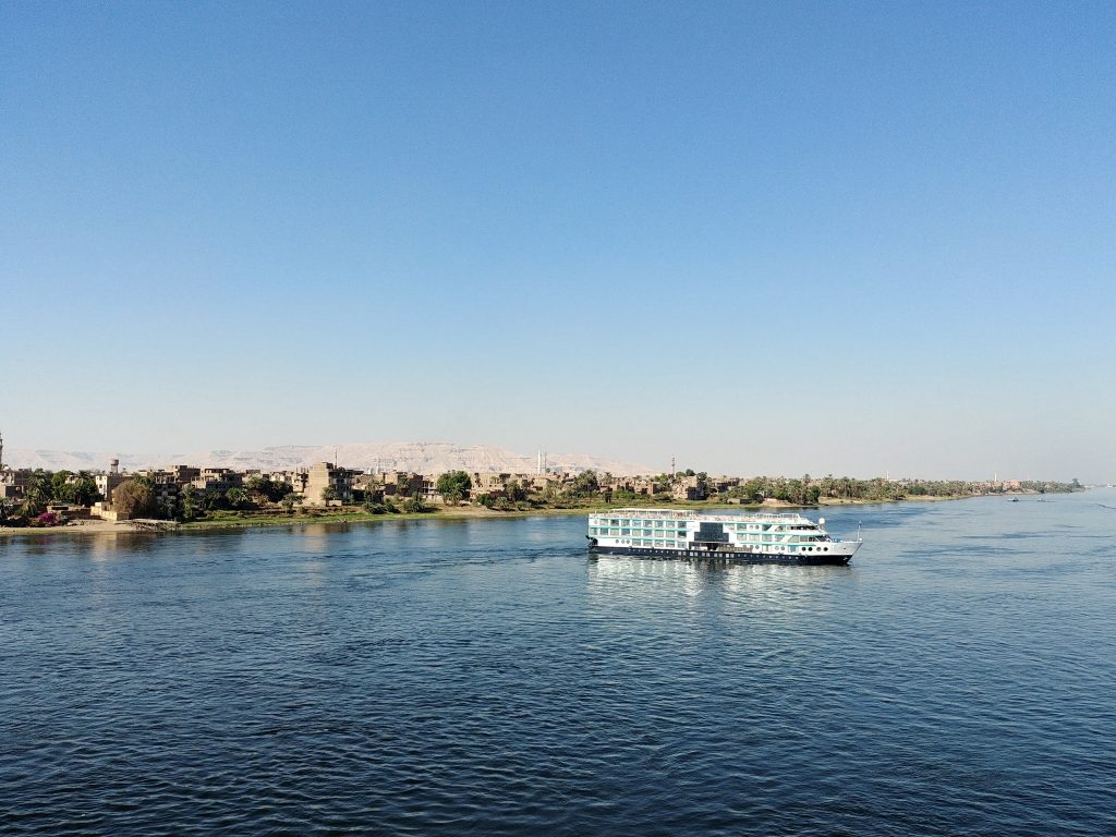 while crossing the river Nile, a boat is standing in the middle of the river in Luxor