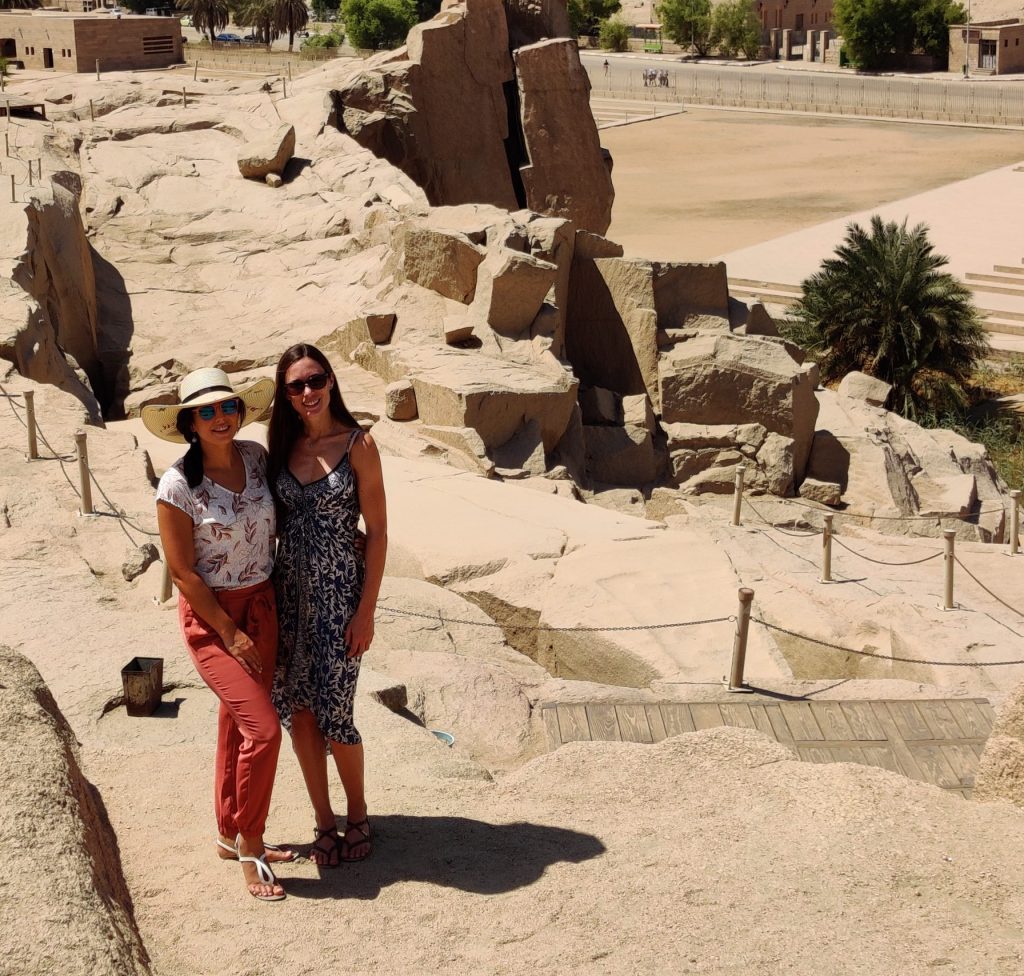 two girls stand next to the unfinished Obelisk in Aswan