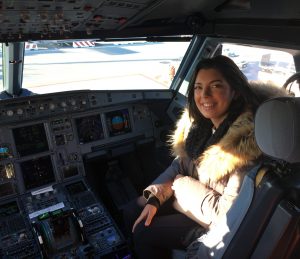 a girl is sitting in the cockpit of a plane