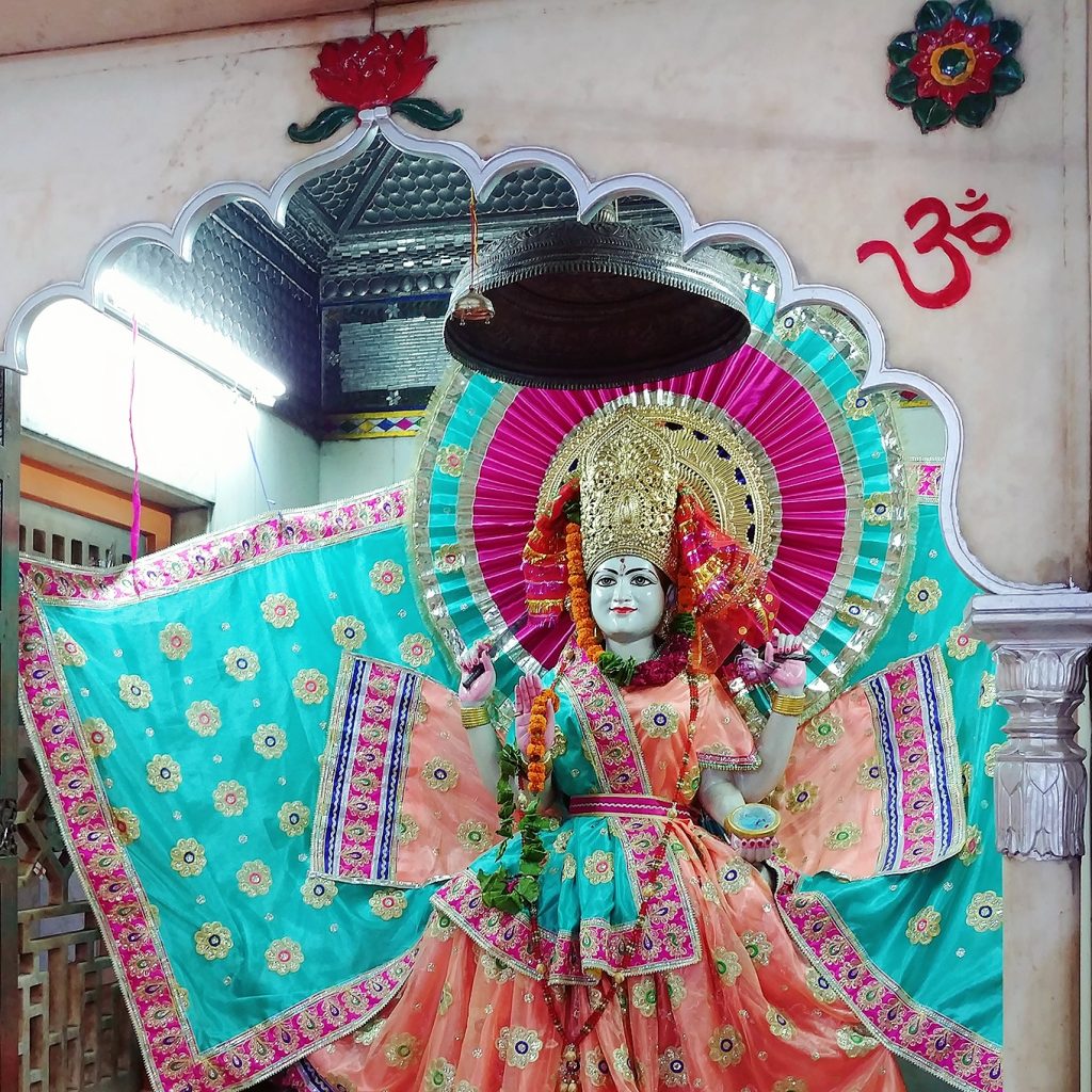 one of the god representation is wearing colorful attires inside the temple