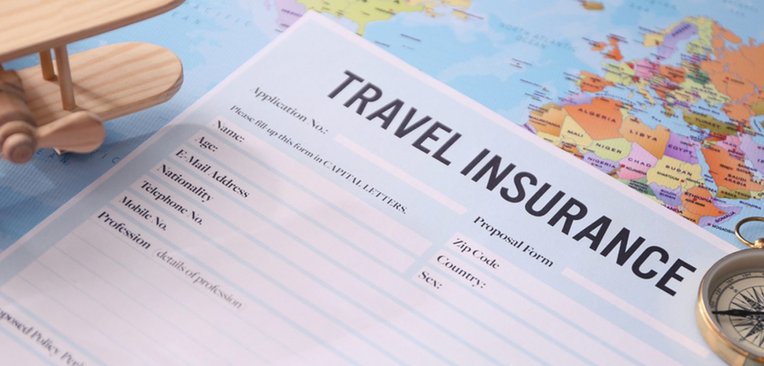 a travel insurance contract surrounded by passport and flight tickets