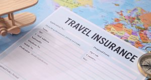 a travel insurance contract surrounded by passport and flight tickets